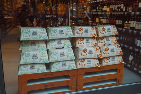 Pisa, Italy - March 18, 2023: Many special panettone italian Christmas cakes detail through a window...