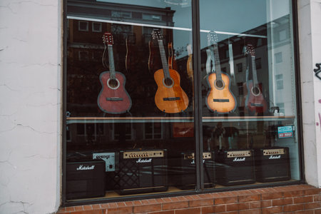 Gdansk, Poland - November 11, 2022:Acoustic guitars of different colors and types on a musical...