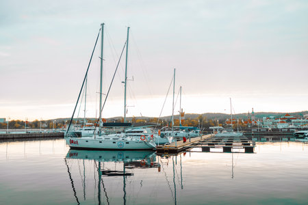 Sopot, Poland - October 13, 2022: Luxury yachts docked in sea port at sunset. Marine parking of modern motor boats and blue water. Tranquility, relaxation and fashionable vacation. High quality photoのeditorial素材