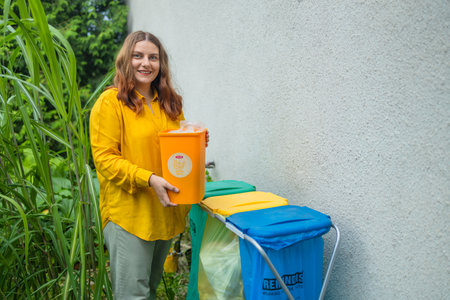 young woman throws garbage bag in the trash sorting waste, female in casual wear, eco-friendly person save planet, environment by pollution contamination.の写真素材
