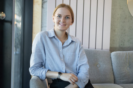 Cafe city. Portrait of happy young office assistant working remotely online sitting using mobile...