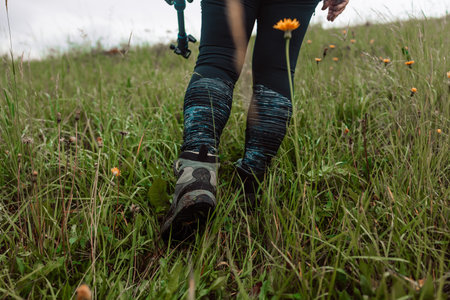 A woman is holding her knee joint in excruciating pain at uphill road. High quality photoの写真素材