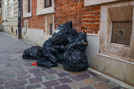 closeup of plastic bags garbage stacked in the street. High quality photoの写真素材