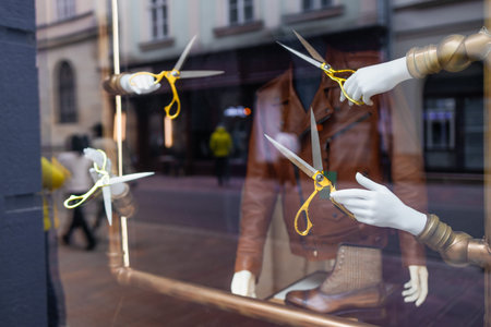 Mannequin hand holding hair scissors on white background. Minimalism beauty concept. High quality...