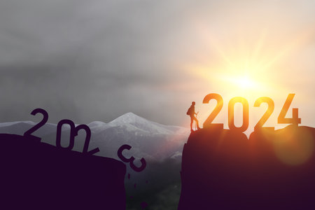 Loading year 2024. Successful lucky man to the top of the mountain from 2024 year number. Business start up or goal to success. High quality photoの写真素材