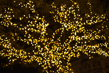 Winter holidays. Christmas decorations on the street, colorful holiday bokeh lights, city night illumination, abstract blurry festive backgroundの写真素材