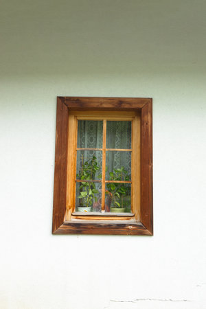 One old window with wooden frame, a fragment of the facade of an old building in Tatra Mountains, Poland.の写真素材