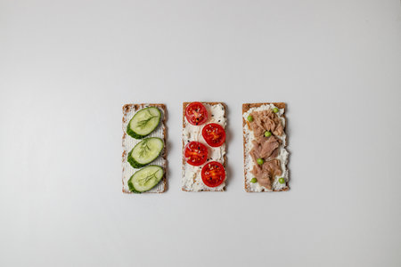 Ingredients for sandwich with boiled egg, cherry tomatoes, canned tuna, garlic and spices on grey white background. High quality photoの写真素材
