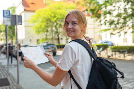 Woman with city map and smart phone. Fantastic view of the ancient homes on a sunny day. Gorgeous and picturesque scene. Location famous Market Square in Wroclaw, Poland, Europe. Historical capital of Silesia. Beauty world. Soft filter. High quality photoの写真素材