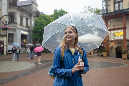portrait of a girl walks in the autumn city under an umbrella. High quality photoの写真素材