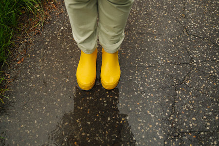 Photo of yellow rubber boots in a building under construction. These rubber boots are waterproof and are often used by construction workers. High quality photoの写真素材