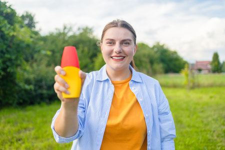 Mosquito repellent. Woman using insect repellent spray outdoors. High quality photoの写真素材