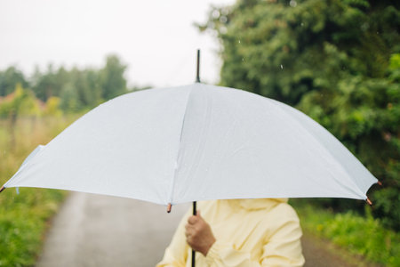 Rain umbrella, city street portrait woman with umbrella on a sidewalk. Happy female person, raining and travel on urban road outdoorの写真素材