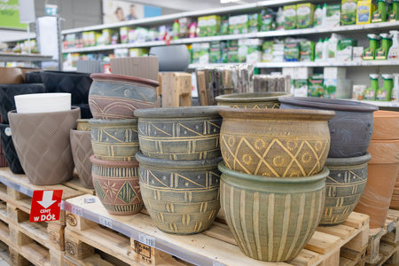 Many colorful flower pots in different sizes in a gardening store. Rows of decorative ceramic pots for houseplants. Ceramic and clay pottery. High quality photoの写真素材