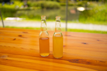 Homemade fresh Apple cider, juice in two glasses and fresh apples on wooden table.の写真素材