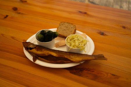 Grilled tuna jaw at restaurant. Happy man with grilled seabass fish and other dishes in a seafood restaurant. High quality photoの写真素材