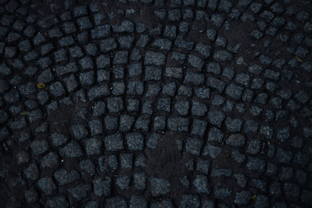 Cobblestone pavement Stone road in the street of old town. Sunlight on cobblestone road in the morning. Old stone texture. High quality photoの写真素材