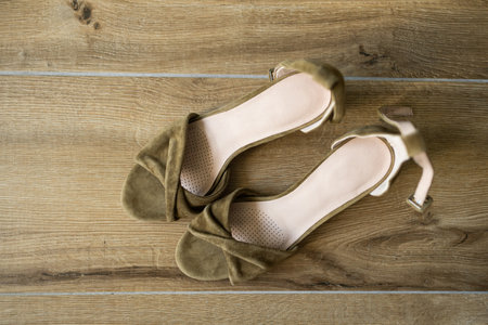 Elegant classic green women leather shoes on pink background. Copy spaceの写真素材
