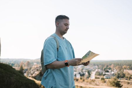 Travel, map and Caucasian man pointing in city for adventure, holiday or directions in MIrow Castle,...