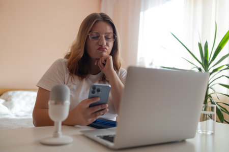 Worried fatigued mature business woman having headache at work. Tired busy 30s aged businesswoman feeling stress at home workplace looking at laptop computer in office. High quality photoの写真素材