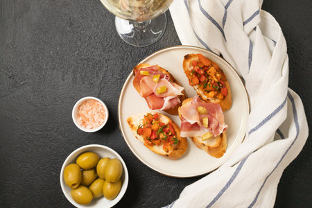 Tasty bruschetta served with wine on gray background. High quality photoの写真素材