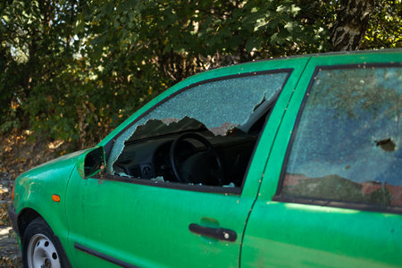 Broken glass on the passenger door of a passenger car parked. High quality photoの写真素材