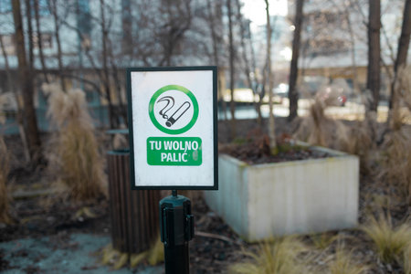Green round information sign indicating smoking area on nature background, health and environmental care concept . High quality photoの写真素材