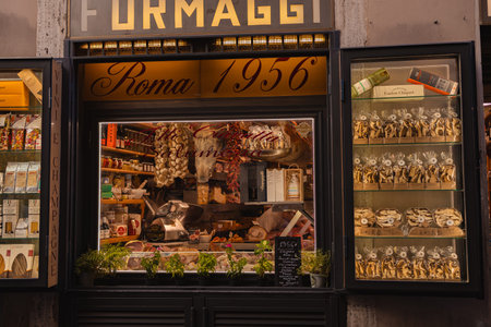 Rome, Italy - October 4, 2025: Traditional Italian gourmet food shop window displaying cheeses,...