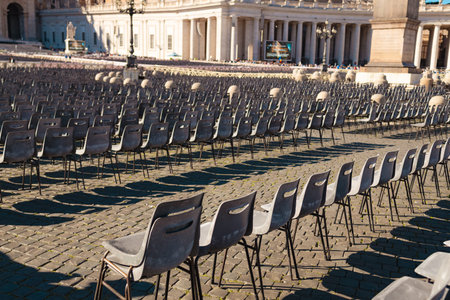 Vatican City October 4 2025 - Rows of empty chairs arranged in St Peter Square in front of St Peter Basilica prepared for public event on sunny day.の写真素材