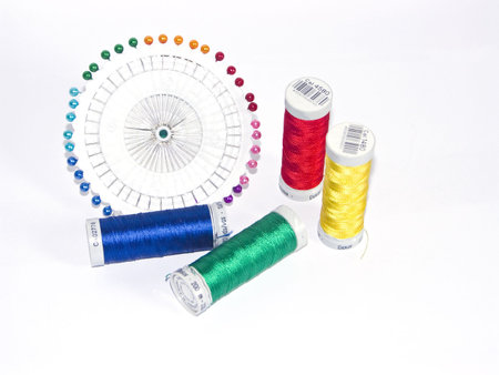 The image of strings for a machine embroidery and pins