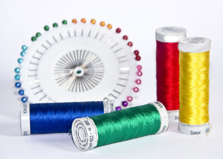 The image of strings for a machine embroidery and pins