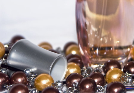 The image of a bottle with perfumery water and the scattered thread of a beadsの写真素材