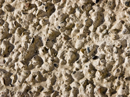 The image of the stones which are sticking out from concrete