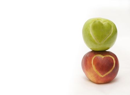 The image of two apples on which hearts are cut outの写真素材