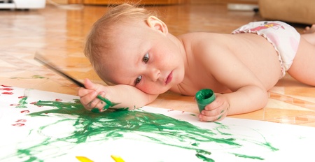 The little girl draws lying on a floorの写真素材