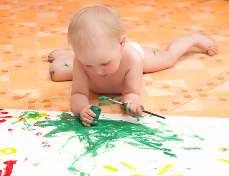 The little girl draws lying on a floorの写真素材