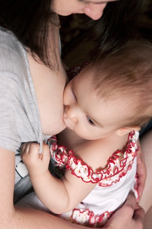 Happy mother breast feeding her little babyの写真素材