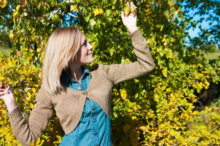 Portrait of a beautiful young woman posing near a treeの写真素材