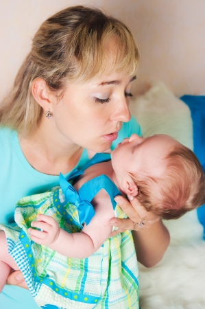 The image of young mother kissing the newbornの写真素材