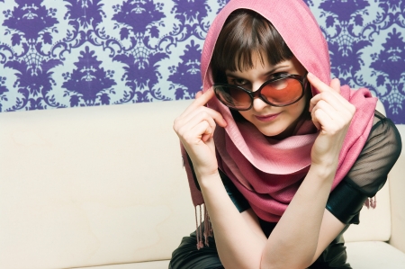 The fashionable girl on a light sofaの写真素材