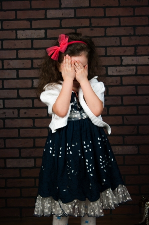 The elegant girl shut the face with the handsの写真素材