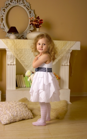 The girl with golden hair standing on a floorの写真素材