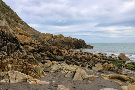 Coast of the Irish Sea with stone boulders.