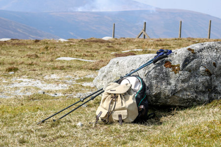 Sticks for a hike and two backpacks. Hike with backpacks in mountains.