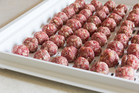 raw meatballs on homemade in the kitchenの写真素材