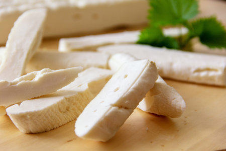 Fresh homemade cheese from goat's milk, on cutting Board, close up
