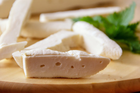 Fresh homemade cheese from goat's milk, on cutting Board, close up