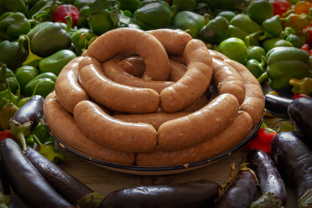 homemade sausage and raw vegetablesの写真素材