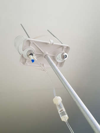 Medical intravenous dropper with medications in bottles bottled by the patient's eyes in the hospital. Intensive care for viral and infectious diseases. Treatment of Coronavirus Covid-19 pneumoniaの写真素材