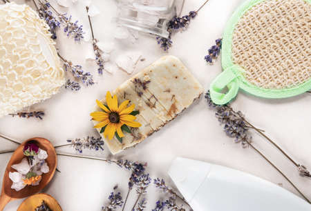 Handmade soap from herbs and oils, lavender, washcloths, sea salt and a bottle of oils for spa treatments on a white background. soap made from natural ingredients for spa and beauty treatmentsの写真素材